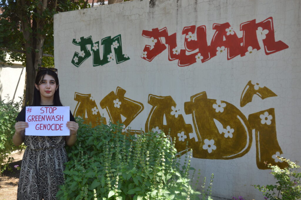 A young woman holding a sign reading 